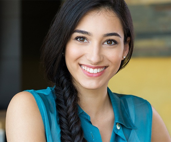 Woman with flawless smile after tooth-colored fillings