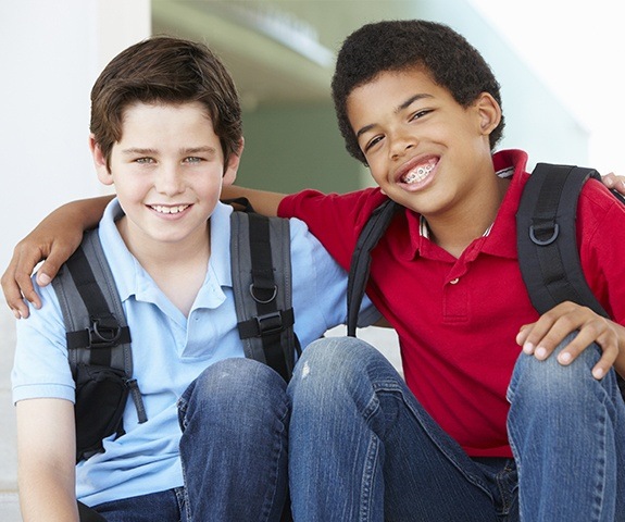 Two young boys with healthy smiles after children's dentistry visit