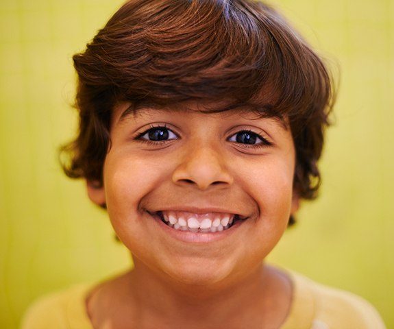 Child's healthy smile with dental sealants