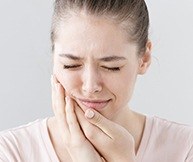 Woman with toothache holding cheek