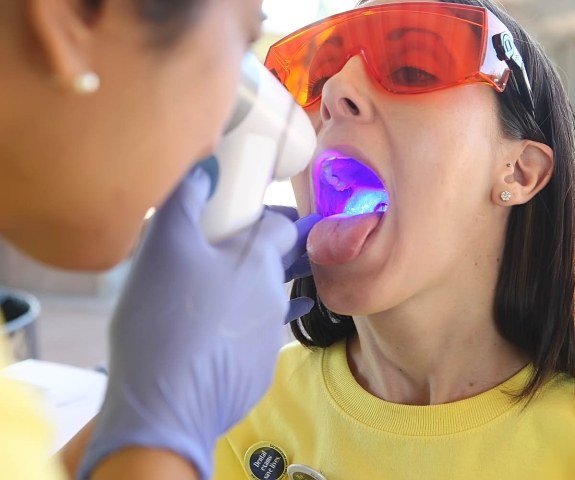 Dentist performing oral cancer screening