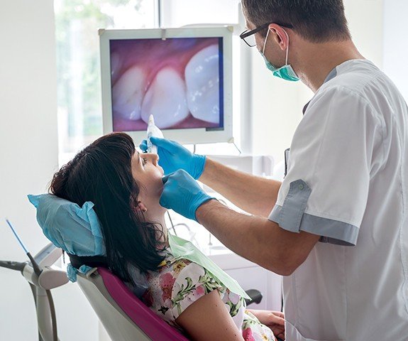 Dentist and dental patient looking at intraoral images